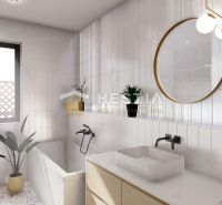 Bathroom in a family house with a bathtub, window, plant, and round mirror.