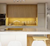 A kitchen in a family house with a wooden decor floor and built-in appliances.