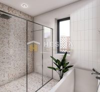 Shower corner with terrazzo tiles and white tiles in the bathroom of a family house.