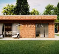 A family house in Hlboké with brick cladding, a terrace, and a green lawn.