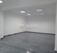 White room with tiling and built-in lighting, intended for commercial use.