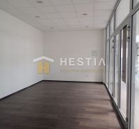 A spacious room with glass doors and a wooden decor floor in a 2-room apartment.