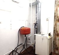 Heating and plumbing in a family house, floor with wooden decor.