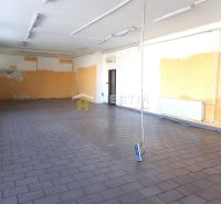 A spacious room with a tiled floor, light-colored walls, and lighting in a family house.
