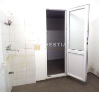The interior of a family house with white walls, doors, and bathroom tiles.