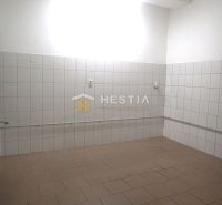 Room with white tiles and a radiator in a family house.