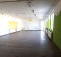 A spacious room with tiles and colorful walls in a family house.