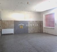Empty room with tiles, radiator, and large window in a family house.