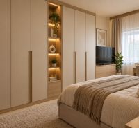 A bedroom in a family house with a large wardrobe and a floor with a wooden decor.