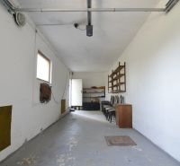 A garage with white walls and storage space in a family house.