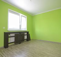 Bright room with wood-patterned flooring in a family house.