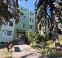 Apartment building on Pod hájkom Street in Skalica surrounded by greenery and trees.