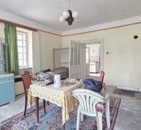 Living room in a family house with retro furniture, table and chairs, television.