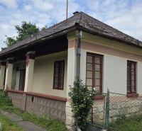 A family house in Boldogkőújfalu with traditional architecture and a stone fence.
