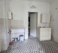 The interior of a family house with tiles and white furniture.