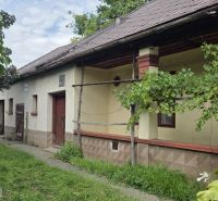 A family house in Boldogkőújfalu surrounded by greenery and a garden, with traditional architecture.