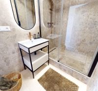 Bathroom with a shower, mirror, and modern sink in a 3-room apartment.