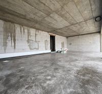 A facility with a concrete ceiling and floor in commercial premises.