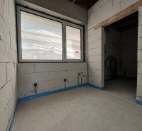 Interior with unfinished walls, a window, and preparations for electrical installations in commercial spaces.
