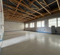 Commercial premises with wooden decor on the floor and large windows, Lipany.