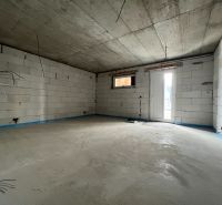 Empty commercial spaces with concrete floors and white bricks.