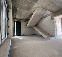Concrete staircase in commercial premises with light entering through the window and door.
