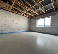 Interior of commercial premises with unfinished walls and a wooden ceiling.