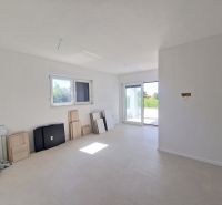 A bright room with large windows, tiles, and prepared materials in a 3-room apartment.