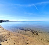 Sandy beach with clear water in Privlaka, ideal for relaxing by the sea.