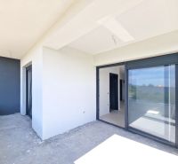 A balcony in a 3-room apartment in Privlaka with large sliding windows.