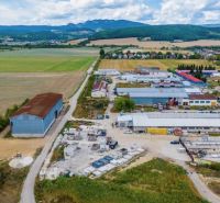 Aerial view of warehouses and halls in Dulov with surrounding nature.