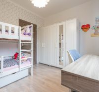 Children's room with a bunk bed, wardrobe, and wooden decor flooring in a 3-room apartment.