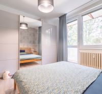 Bright bedroom with a wardrobe, bed, and window, suitable for a 3-room apartment.