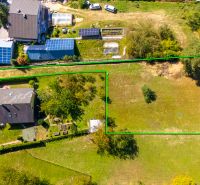 A residential plot on Sládkovičova Street in Považská Bystrica surrounded by nature and houses.