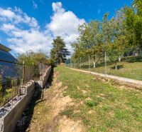 Grassy slope with a fence on Sládkovičova Street in Považská Bystrica, Land - residential.