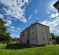 An apartment building with a lawn and a clear sky on Kpt. Uhra Street in Myjava.