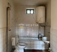 A bathroom in a family house with a bathtub, toilet, and sink.