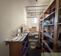 Storage space in a family house with supplies, shelves, and kitchen necessities.