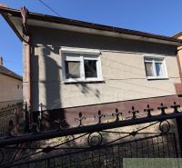 A family house in Tvrdošovce, shown behind an iron fence.