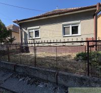 A family house in Tvrdošovce with a small front garden and a metal fence.