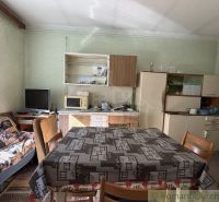 A kitchen corner with a dining table and a sofa in a family house.