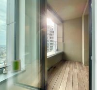 A balcony with a view in a 2-room apartment, floor with wooden decor.