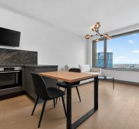 Kitchen with a dining table, sofa, and large window, 2-room apartment.