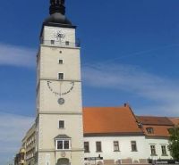 City Tower in Trnava near a 2-room apartment, blue sky, historical character.