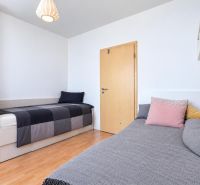 Children's room in a 3-room apartment, two beds, wooden decor flooring, simple furniture.