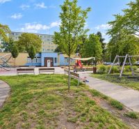 Playground on Gallayova Street in Bratislava-Dúbravka with greenery and swings.
