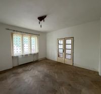 The interior of a family house with white walls and a floor with a wooden decor.