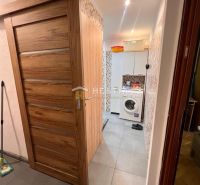 Bathroom in a 3-room apartment with a washing machine and doors with a wooden decor.