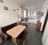 A kitchen in a 3-room apartment with a corner unit, a dining area, and tiles.