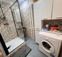 Cozy bathroom with a shower and a washing machine in a 3-room apartment.
